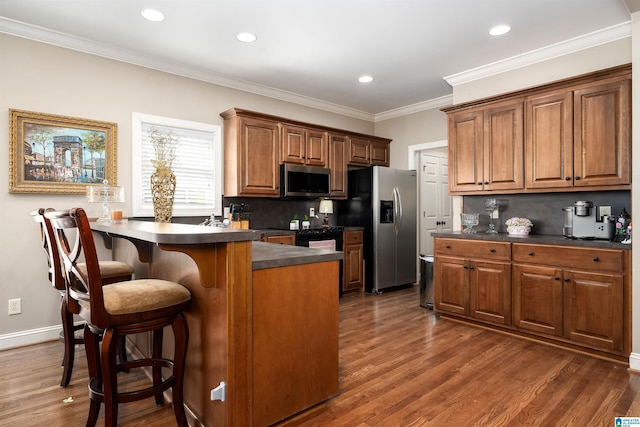 7717 Clayton Cove Pkwy, Clay, AL 35126 - kitchen with tasteful backsplash, dark countertops, a kitchen breakfast bar, and stainless steel appliances