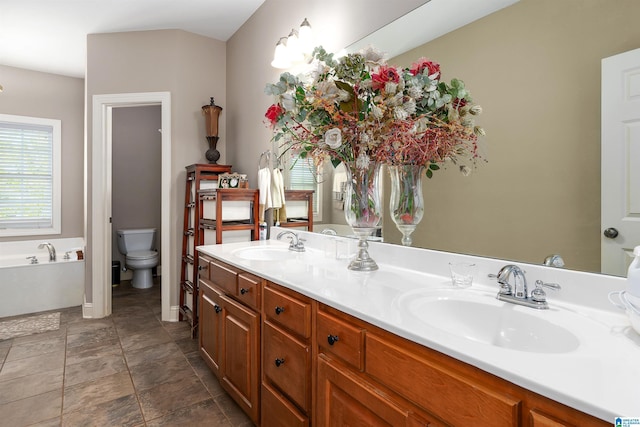 7717 Clayton Cove Pkwy, Clay, AL 35126 - bathroom with toilet, a bath, double vanity, and a sink