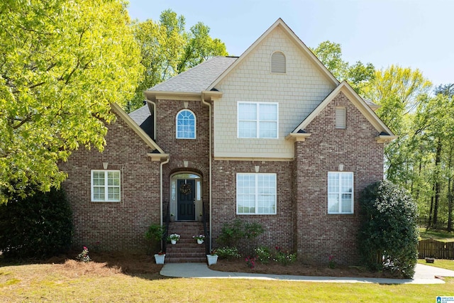 7717 Clayton Cove Pkwy, Clay, AL 35126 - traditional-style house with a front yard, brick siding, and roof with shingles