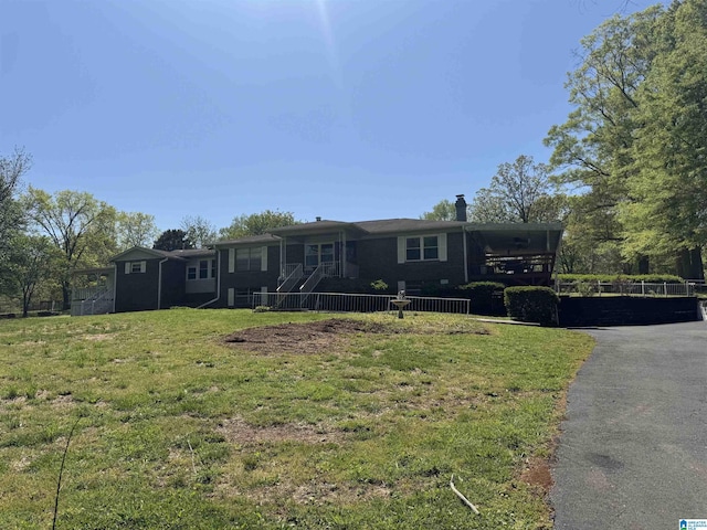 single story home featuring a chimney and a front yard