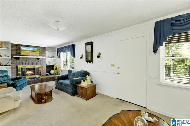carpeted living area featuring crown molding, a textured ceiling, and a fireplace