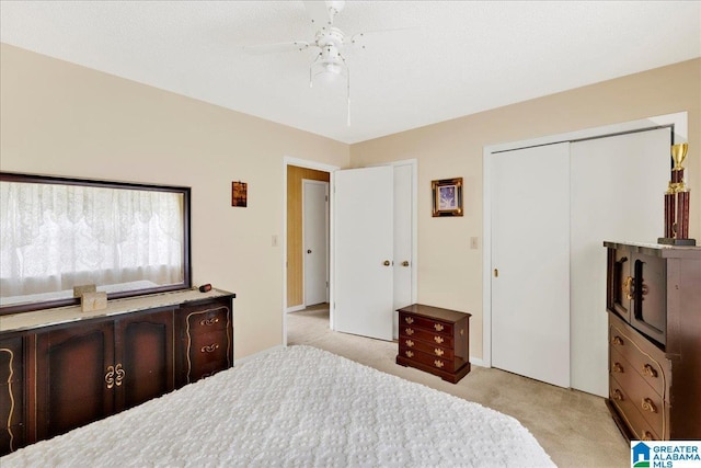 bedroom with light carpet, a closet, and ceiling fan