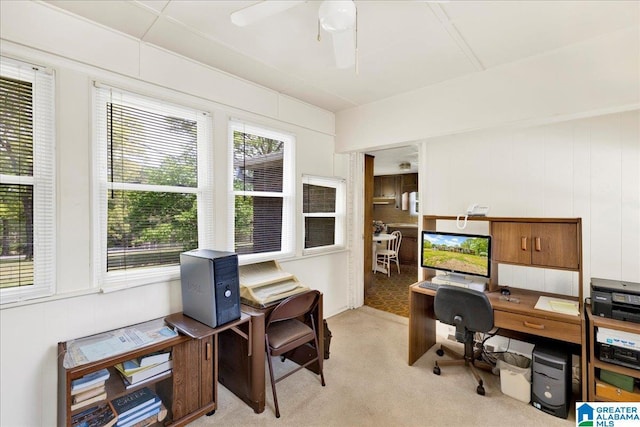 office space featuring light carpet and a ceiling fan