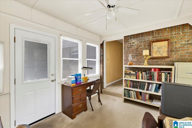 carpeted office space featuring ceiling fan