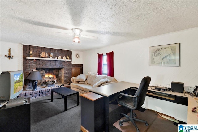 office area featuring a brick fireplace, carpet, a textured ceiling, and ceiling fan
