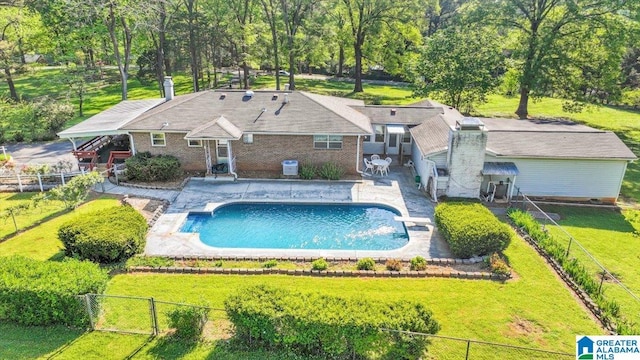 view of swimming pool featuring a fenced backyard, a fenced in pool, and a yard