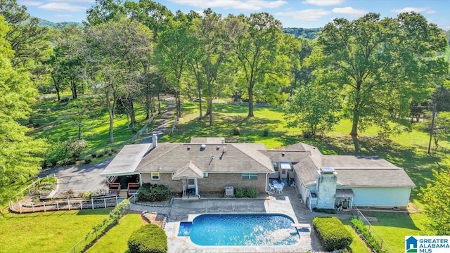 pool with fence, a patio area, a yard, and area for grilling
