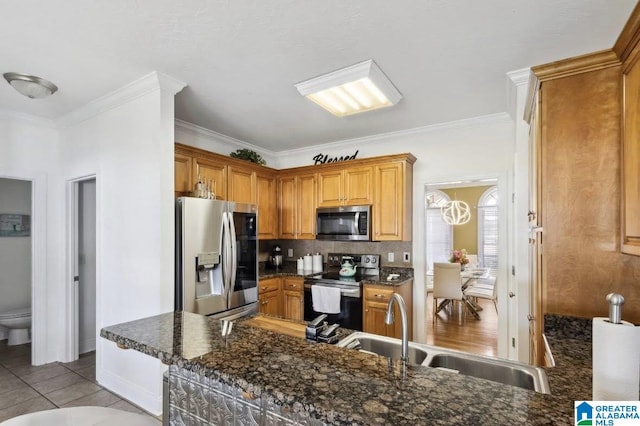 kitchen featuring a sink, appliances with stainless steel finishes, crown molding, and backsplash