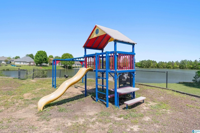 community play area with fence and a water view