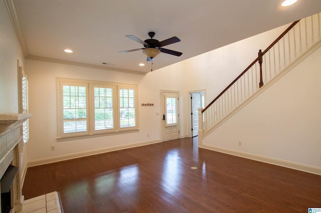 3881 Ross Park Dr, Hoover, AL 35226 - unfurnished living room featuring dark wood finished floors, a tiled fireplace, baseboards, a ceiling fan, and stairs
