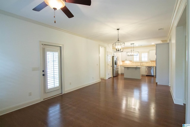3881 Ross Park Dr, Hoover, AL 35226 - unfurnished living room featuring dark wood finished floors, a sink, crown molding, baseboards, and ceiling fan with notable chandelier
