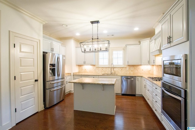 3881 Ross Park Dr, Hoover, AL 35226 - kitchen featuring ornamental molding, appliances with stainless steel finishes, a sink, and a kitchen island