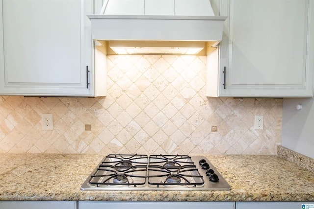 3881 Ross Park Dr, Hoover, AL 35226 - kitchen featuring white cabinets, light stone counters, backsplash, stainless steel gas cooktop, and custom exhaust hood