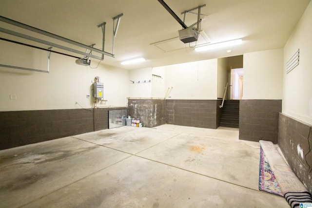 3881 Ross Park Dr, Hoover, AL 35226 - garage featuring concrete block wall, a garage door opener, and wainscoting