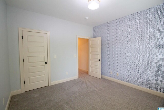 3881 Ross Park Dr, Hoover, AL 35226 - spare room with baseboards, wallpapered walls, and carpet