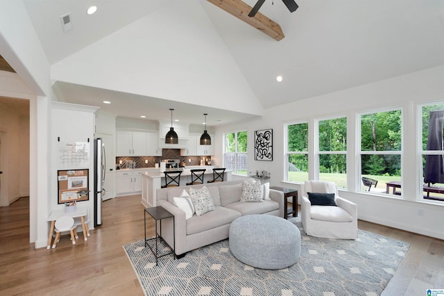 living area with recessed lighting, ceiling fan, beam ceiling, light wood-type flooring, and high vaulted ceiling
