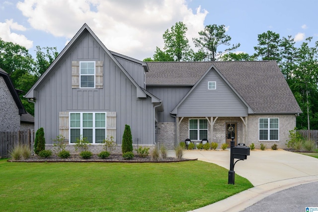 view of front facade featuring a front lawn, board and batten siding, and fence