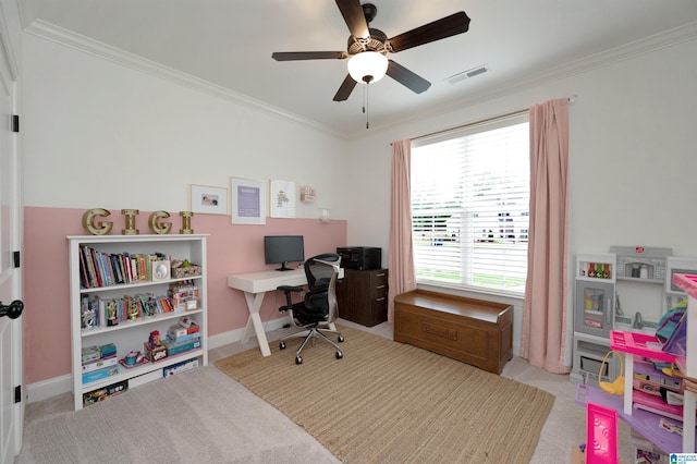 carpeted home office featuring baseboards, visible vents, a ceiling fan, and crown molding