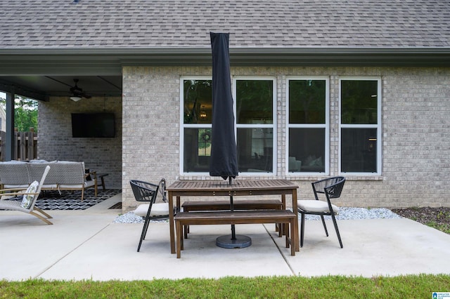 view of patio featuring fence, a ceiling fan, and outdoor dining area
