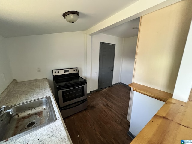 kitchen with dark wood-type flooring, a sink, and stainless steel electric stove