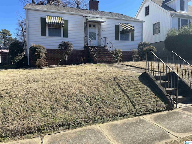view of front facade with a front lawn and a chimney