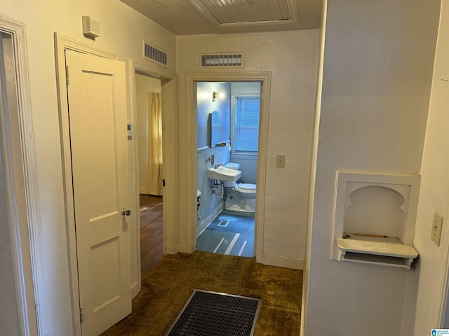 hallway with carpet and visible vents