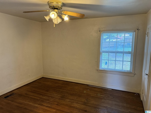 empty room featuring visible vents, baseboards, a ceiling fan, and wood finished floors