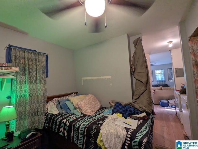 bedroom with a ceiling fan and wood finished floors