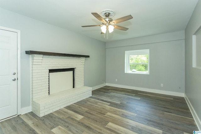122 Mims Cir, Clanton, AL 35045 - unfurnished living room featuring ceiling fan, a brick fireplace, and wood finished floors