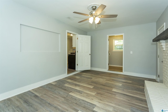 122 Mims Cir, Clanton, AL 35045 - unfurnished bedroom featuring a fireplace, wood finished floors, and a ceiling fan