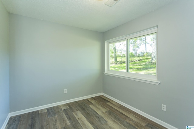 122 Mims Cir, Clanton, AL 35045 - empty room featuring dark wood-style floors and a textured ceiling