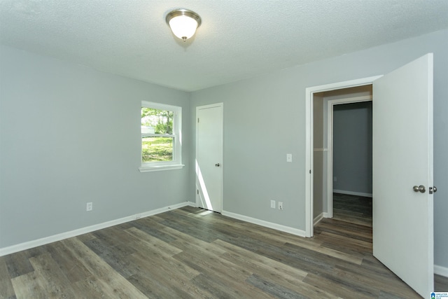 122 Mims Cir, Clanton, AL 35045 - empty room with dark wood finished floors and a textured ceiling