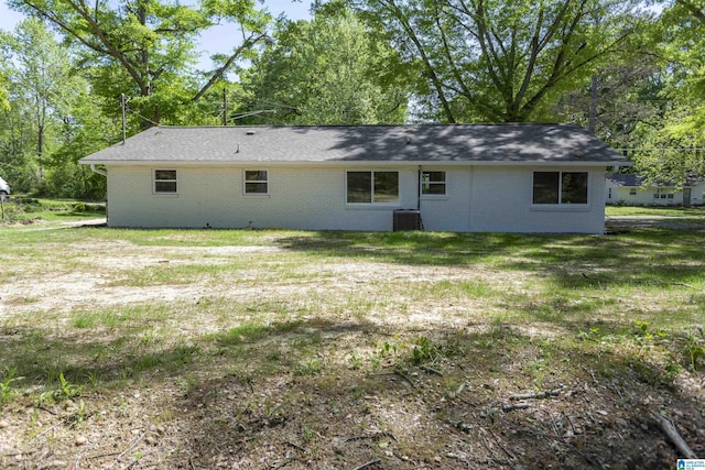 122 Mims Cir, Clanton, AL 35045 - back of house with brick siding, a lawn, and view of wooded area
