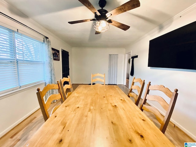 dining area with a ceiling fan, wood finished floors, baseboards, and ornamental molding