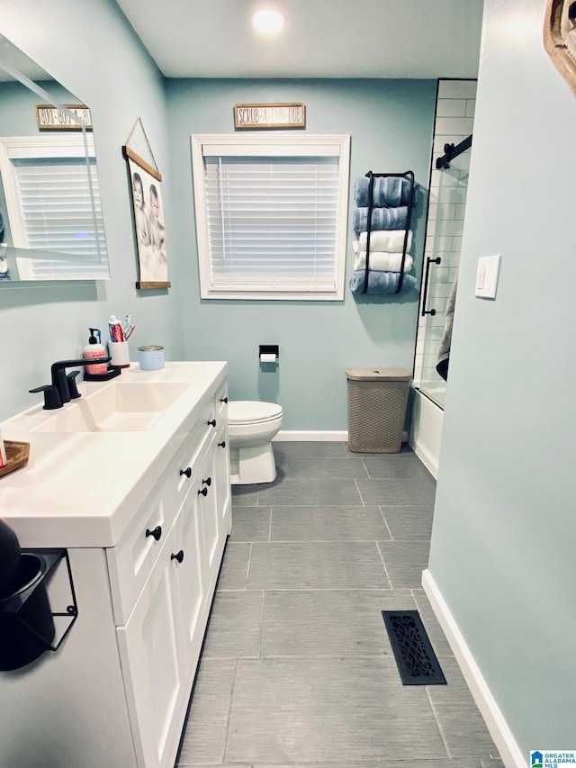 full bath featuring vanity, visible vents, toilet, combined bath / shower with glass door, and baseboards