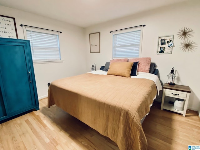 bedroom with baseboards and light wood-style floors