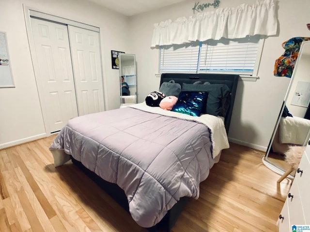 bedroom featuring a closet, baseboards, and wood finished floors