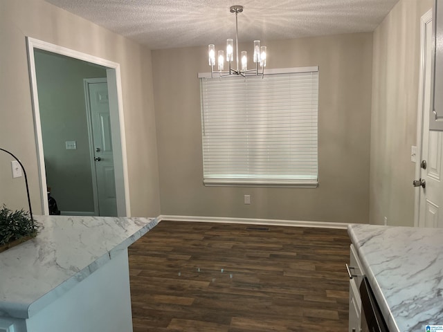 54 Setter Dr, Anniston, AL 36207 - dining space featuring dark wood-style flooring, a chandelier, a textured ceiling, and baseboards