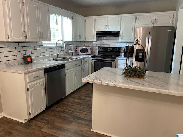 54 Setter Dr, Anniston, AL 36207 - kitchen with appliances with stainless steel finishes, under cabinet range hood, a sink, and white cabinets