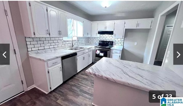 54 Setter Dr, Anniston, AL 36207 - kitchen with appliances with stainless steel finishes, a sink, under cabinet range hood, and white cabinetry