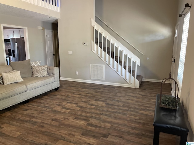 54 Setter Dr, Anniston, AL 36207 - living room featuring stairway, dark wood-style flooring, baseboards, and a high ceiling