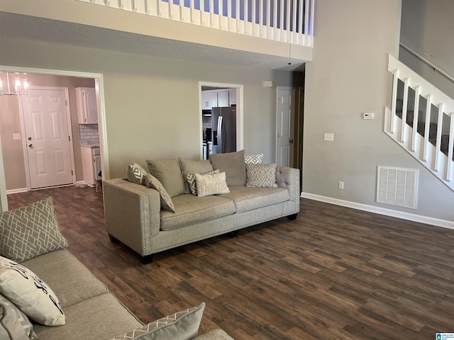 54 Setter Dr, Anniston, AL 36207 - living area featuring stairs, dark wood-style floors, baseboards, and a high ceiling