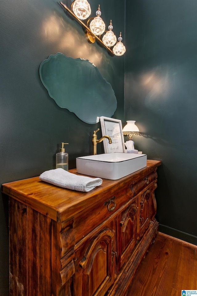 bathroom featuring baseboards, vanity, and wood finished floors