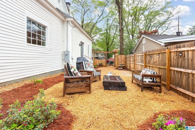 view of patio featuring a fenced backyard and an outdoor fire pit
