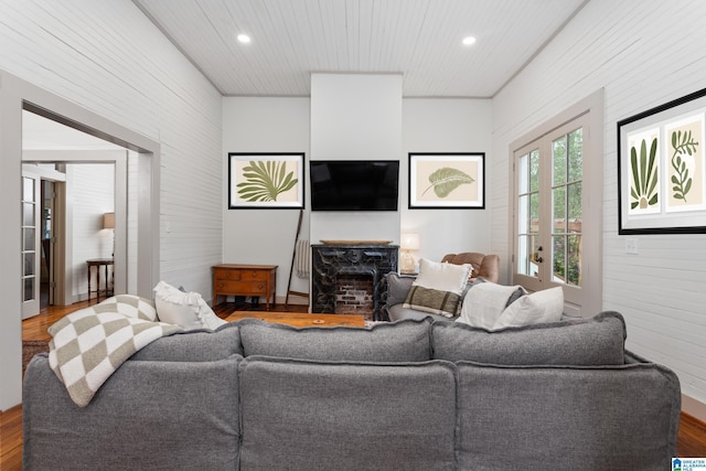living area featuring recessed lighting, wood finished floors, and wood walls