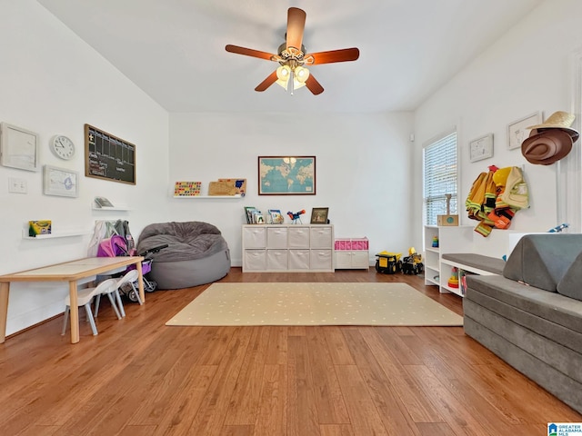 living area with a ceiling fan and wood finished floors