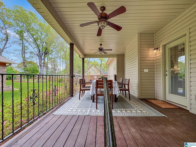 deck with outdoor dining area and a ceiling fan