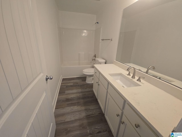 full bath featuring toilet, wood finished floors, vanity, and bathing tub / shower combination
