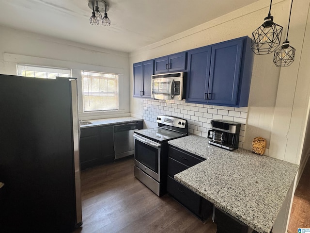 kitchen with blue cabinets, stainless steel appliances, a peninsula, decorative backsplash, and dark wood-type flooring