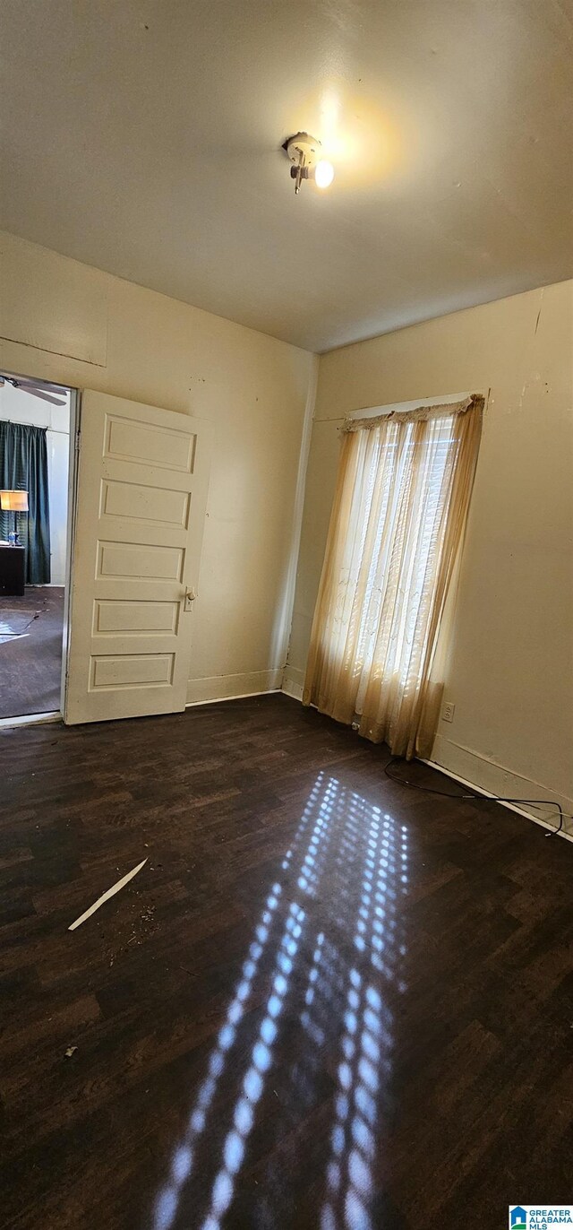 18 6th Ave S, Birmingham, AL 35205 - unfurnished room with wood finished floors and baseboards